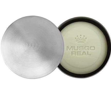 Top view of an open round shaving bowl of Claus Porto Musgo Real Classic Scent Shaving Soap, with the lid placed beside it showing the Claus Porto 1887 logo.