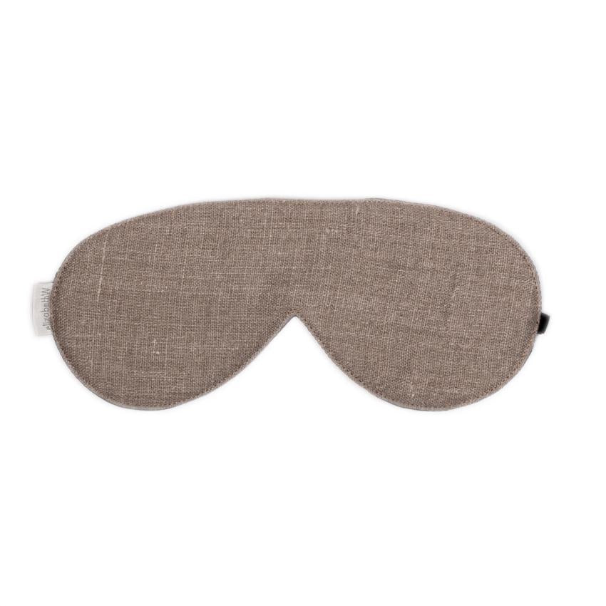 A gray, fabric elizabeth W Washed Natural Linen Sleep Mask with an adjustable velvet elastic strap, isolated on a white background. The mask has a contoured design to fit comfortably over the eyes.