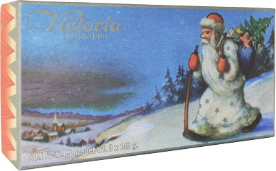 Vintage soap packaging featuring a classic Santa Claus figure with a staff and Christmas tree, against a snowy village landscape, labeled as "Victoria Swedish Christmas Soaps - Santa White Suit" by Victloria Scandinavian Soaps.
