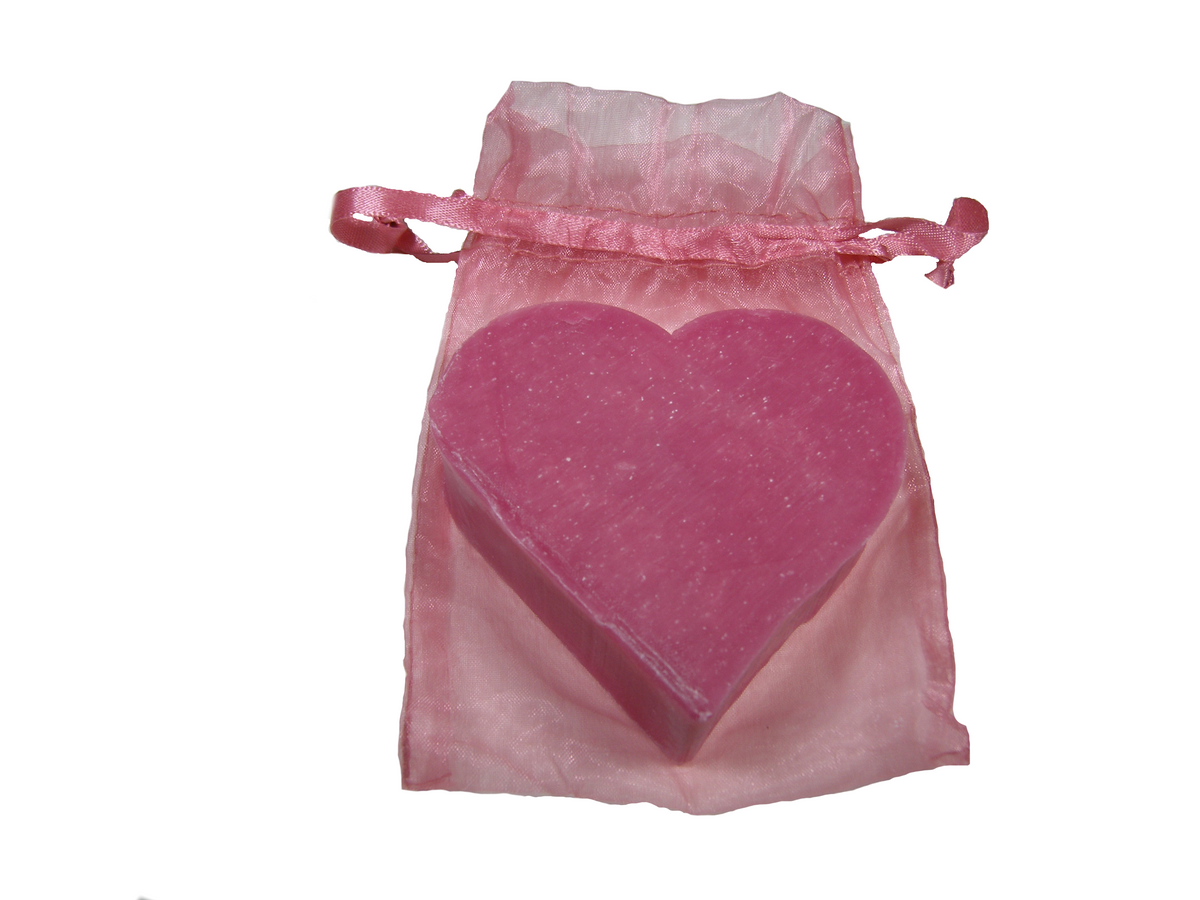 A pink, heart-shaped Massalia Heart Soap - Passion Fruit of Marseille inside a translucent pink organza bag tied with a matching pink ribbon, isolated on a white background. Made in Provence.