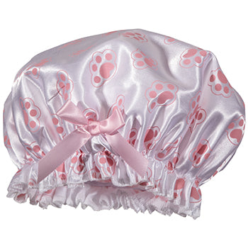 A Fancy Shower Cap - Paw Design by Shower Caps with bow and ruffled edge, adorned with a pattern of darker pink paw prints.