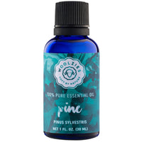 A bottle of Woolzies Pine Essential Oil, labeled as 100% pure and perfect for being diffused, with a blue and green watercolor design. The botanical name Pinus