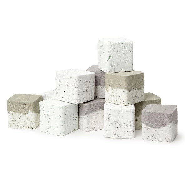 A stack of twelve Lizush Pine Scented Shower Steamers for Fall and Winter, infused with essential oils and made from natural ingredients, in assorted colors of gray and white, arranged in a pyramid shape against a white background.