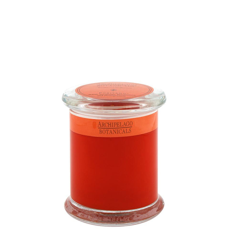 A clear glass jar of Archipelago Excursion Positano Glass Jar Candle filled with bright orange essential oils, sealed with a transparent lid, isolated on a white background.