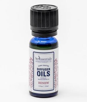 A small blue glass bottle of BC Essentials essential oil blend labeled "Renew". The bottle has a black cap and is set against a plain white background.