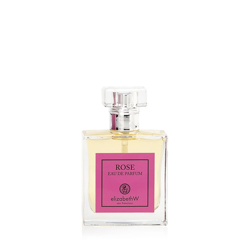 A clear glass perfume bottle with a pink label that reads "elizabeth W Signature Rose Eau de Parfum" by elizabeth W on a white background.
