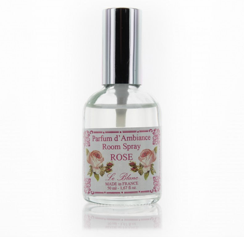 A transparent glass bottle of Le Blanc Made in France room spray with a floral label, against a white background. The bottle contains 50 ml of liquid and is made in France.