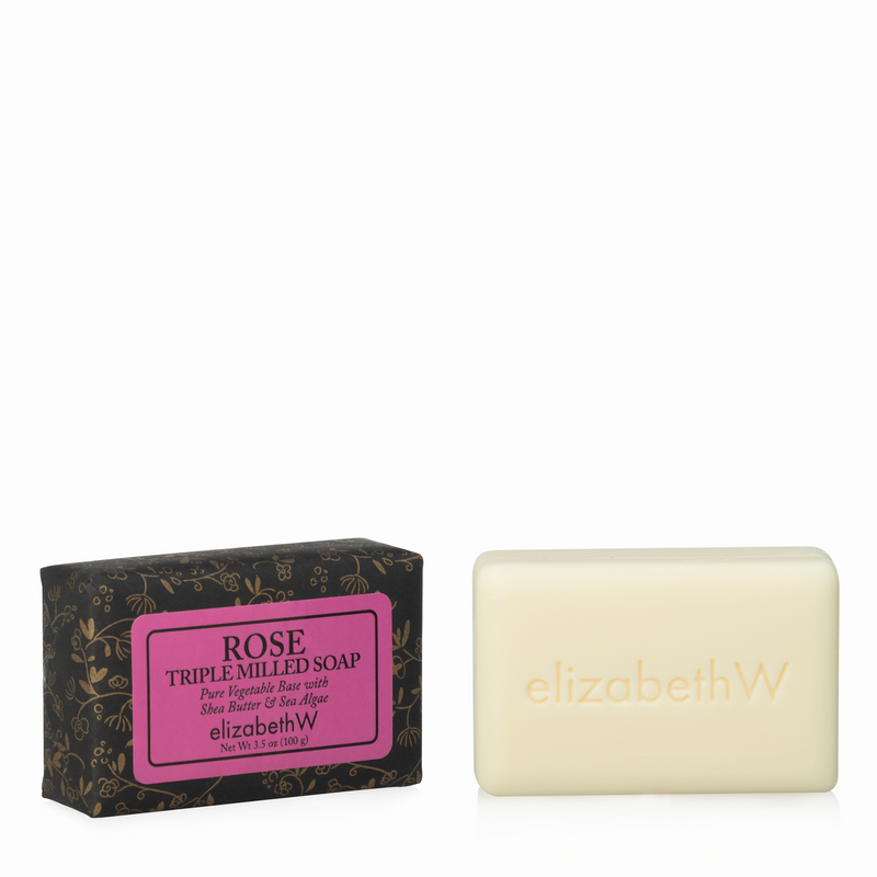 A bar of elizabeth W Signature Rose Soap-3.5 oz next to its black floral-patterned packaging with a prominent pink label.