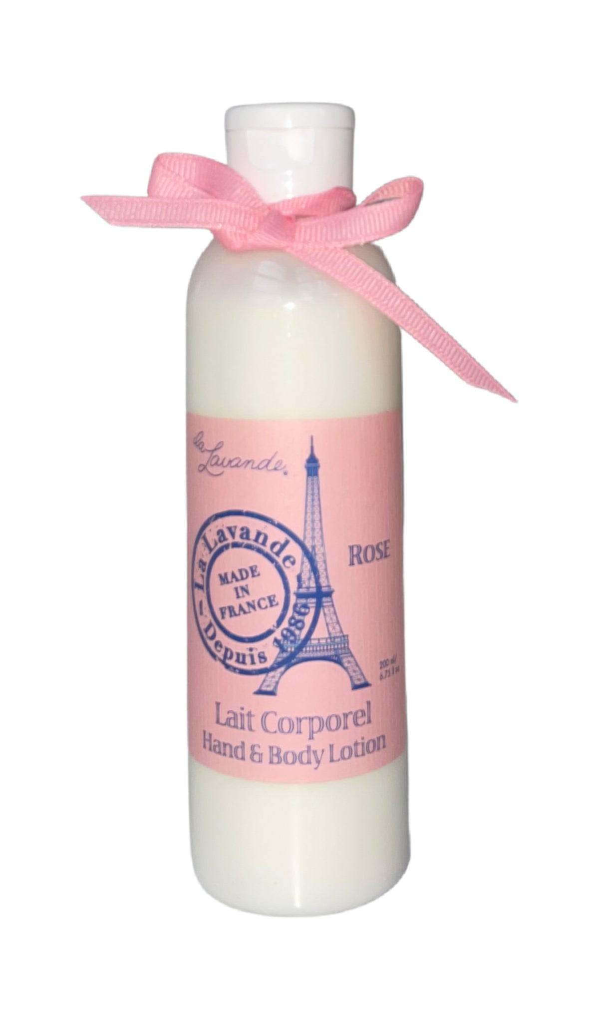 A white bottle of La Lavande Rose Hand & Body Lotion with an Eiffel Tower graphic, labeled "rose," and enriched with shea butter, adorned with a pink bow at the