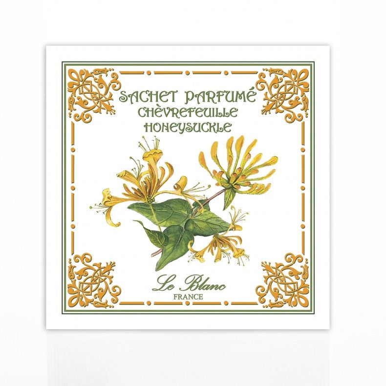 A decorative Le Blanc Honeysuckle scented sachet label featuring an illustration of yellow honeysuckle flowers with green leaves, surrounded by an ornate gold and green border, with the text "sachet parfum" Made in France.