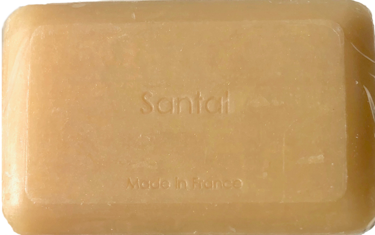 A bar of translucent amber La Lavande Sandalwood Soap with "santal" embossed at the top and "made in France" at the bottom, displayed against a plain background.