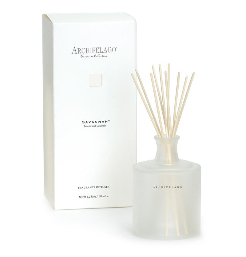 A fragrance reed diffuser with a frosted glass bottle and several reed sticks, labeled "Archipelago Excursion Savannah," accompanied by its rectangular white packaging box.