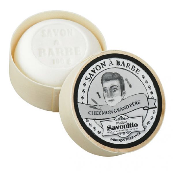 Two circular bars of EA2G Maitre Savonitto Shaving Soap in Wooden Box, one with the lid off showing the embossed soap and the other displaying the vintage-style black and white label featuring a portrait and French text