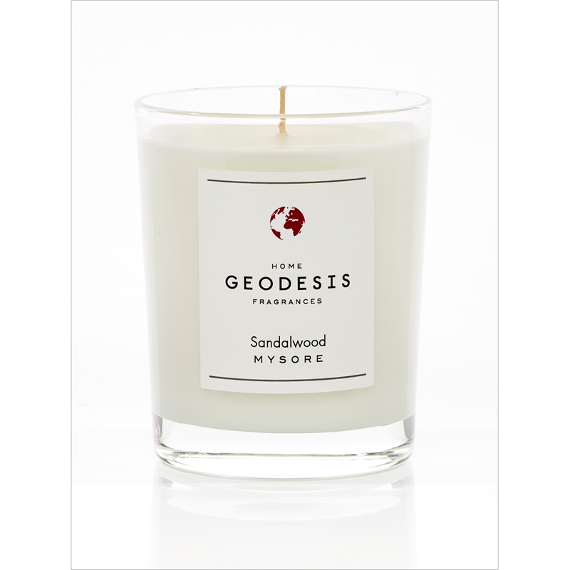 A single white Geodesis Sandalwood 180gm scented candle with a woody scent, in a clear glass container on a white background.