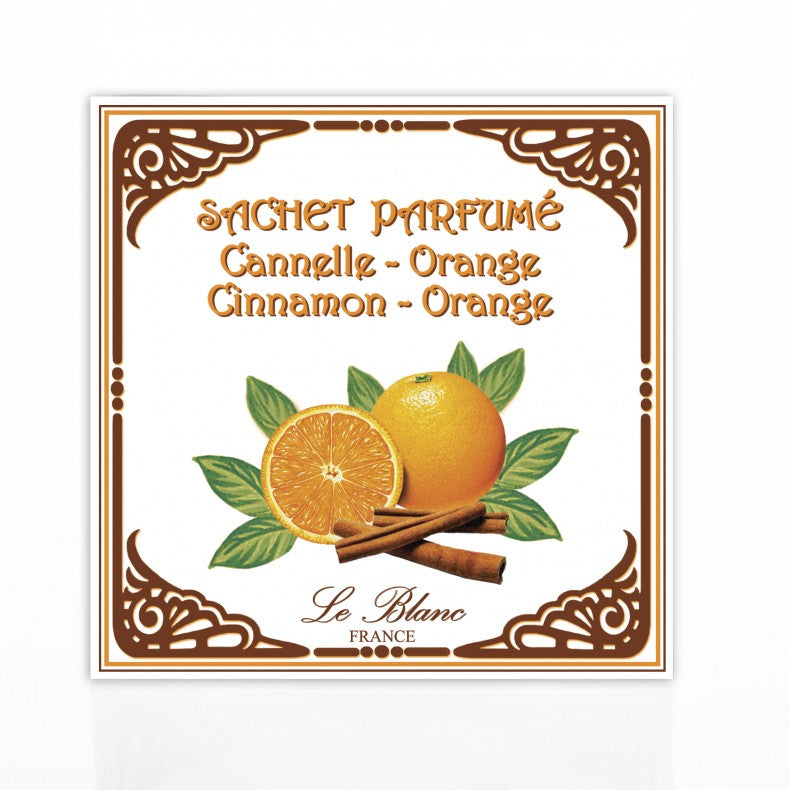 Label depicting a Le Blanc Cinnamon Orange Scented Sachet with orange and cinnamon. Features a whole and halved orange with cinnamon sticks and green leaves, framed in an ornate brown design, text says "Le Blanc Made in France