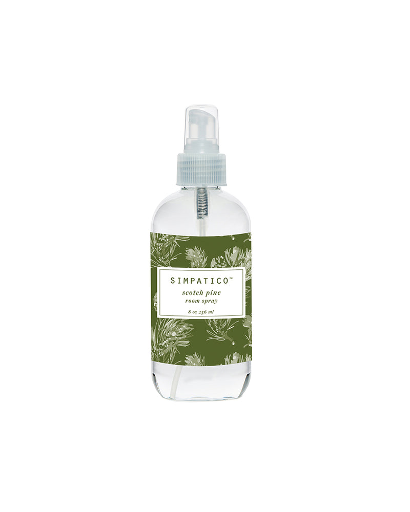 A clear pump bottle labeled "Simpatico Scotch Pine" with a green and white pine needle design containing pine-scented liquid soap.
