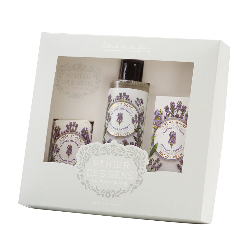A gift set containing three Panier des Sens Lavender Shower Gift Sets: a hand cream, a body lotion, and a shower gel, with elegant floral packaging.