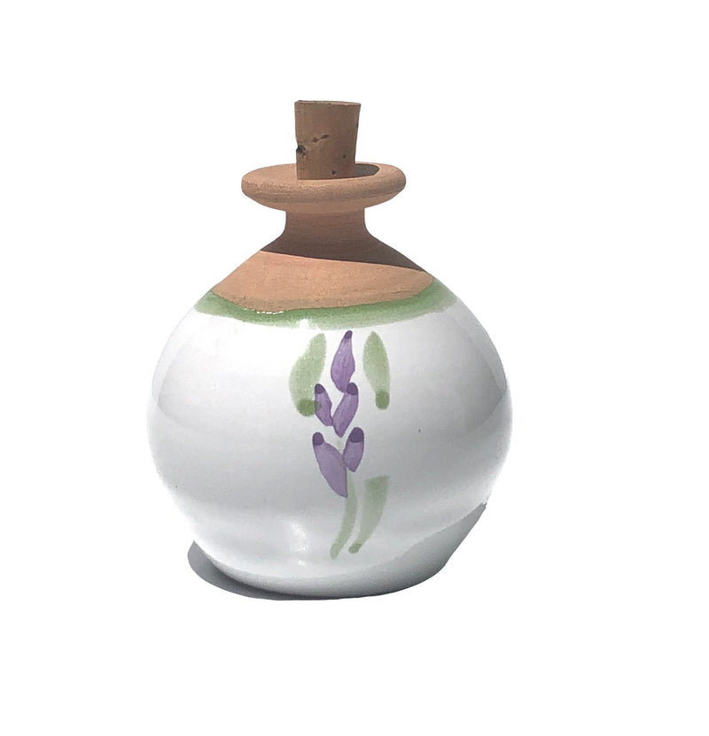 A round La Lavande ceramic lavender essential oil diffuser with a cork stopper, featuring a hand-painted lavender sprig design against a white background, isolated on a white backdrop.