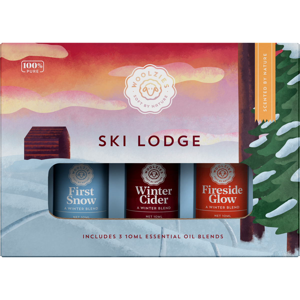 A Woolzies The Ski Lodge Collection package with three winter essential oils blends named first snow, winter glow, and fireside glow against a colorful snowy backdrop with a cabin and trees.