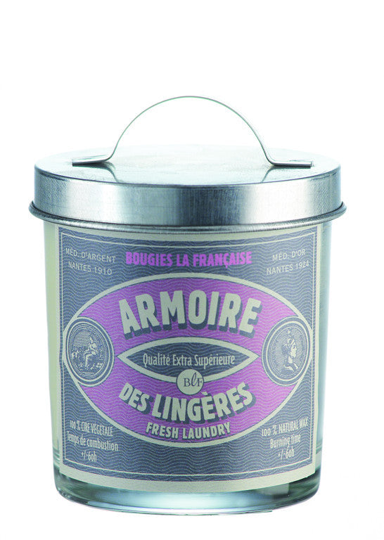 A metal candle tin with a handle labeled "armoire des lingères" in purple and white, indicating it is a Bougies la Francaise Artisan Fresh Laundry Candle w/Galvanized Lid made by Bougies la française.