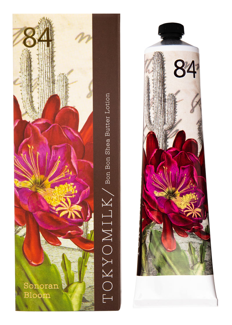 A tube of Margot Elena's TokyoMilk Sonoran Bloom No. 84 Bon Bon Shea Butter Lotion with vibrant floral and saguaro flower imagery on both the packaging and the tube itself.