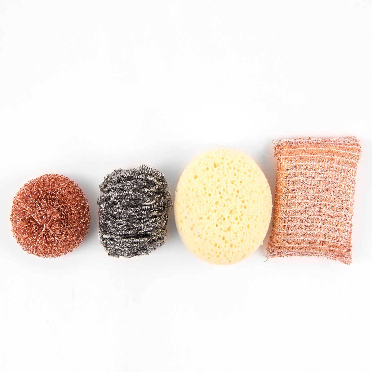 Four different types of Andrée Jardin Tradition Stainless Steel Scrubbers in a row on a white background, including a metallic one and three textured sponges in red, black, and yellow.