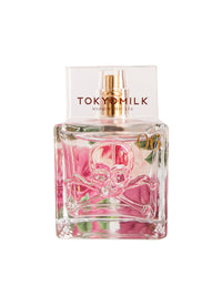 Glass perfume bottle with "TokyoMilk Dead Sexy Elevated Embossed Eau De Parfum" label, featuring a pink liquid and an embossed design of a skull and crossbones on the front. Brand: Margot Elena