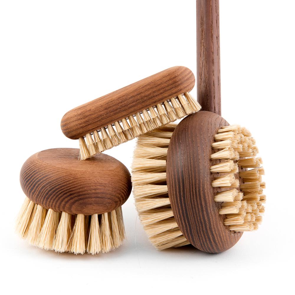 Three Andrée Jardin Heritage Ash Wood Body Brushes with sturdy bristles, varying in size and handle design by Andrée Jardin, arranged on a white background.