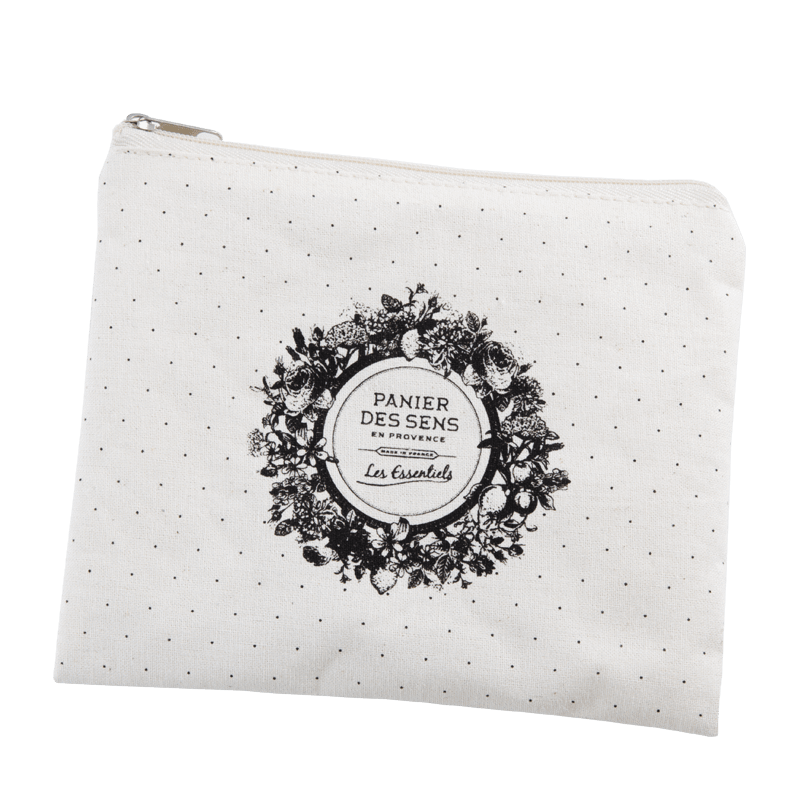 A small, white fabric pouch with a black floral design and text "Panier Des Sens Lavender Travel Pouch - les essentiels" enclosed in a circular frame, against a plain background, infused with Panier Des Sens.