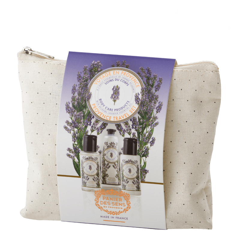 A body care gift set from Panier Des Sens Lavender Travel Pouch, featuring two small bottles and additional products in a beige canvas bag, decorated with a lavender-themed package.