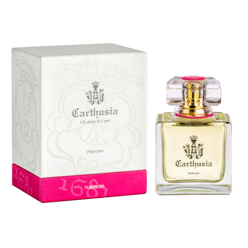 A glass Carthusia I Profumi de Capri perfume bottle labeled "Carthusia Tuberosa Parfum" beside its elegant white and pink box, with "1681" and "tuberose" highlighted on the packaging.