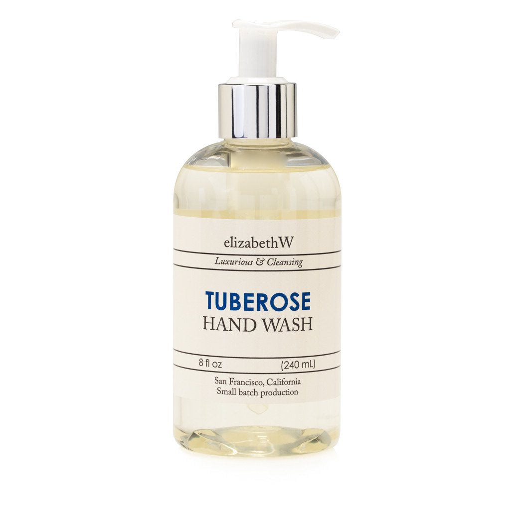 A clear bottle of elizabeth W Small Batch Apothecary Tuberose Hand Wash with a pump dispenser, labeled with product and brand details, isolated on a white background.