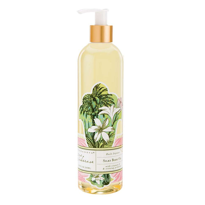 A tall, clear bottle of Terra Nova Tuberose Silky Body Oil with a pump dispenser, decorated with a tropical plant and flower design, labeled as "silky body oil" in elegant script.