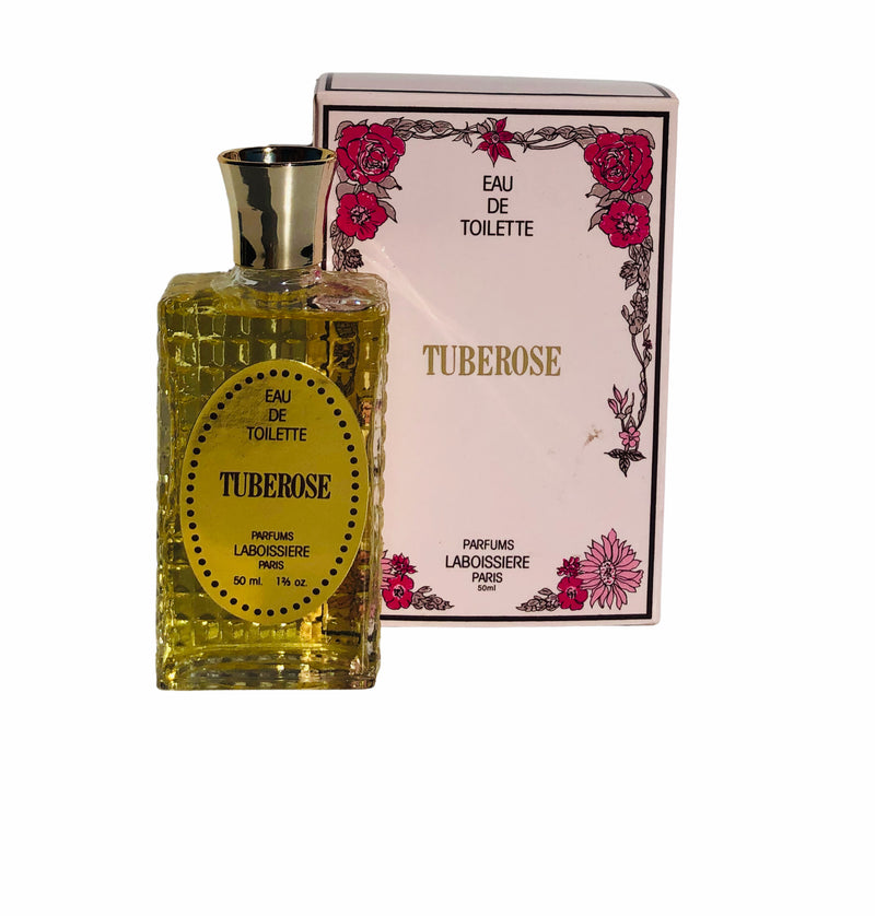 A bottle of "Laboissiere Tuberose Eau de Toilette" perfume next to its packaging. The bottle is transparent with a yellow label and the white box features floral designs and pink accents.