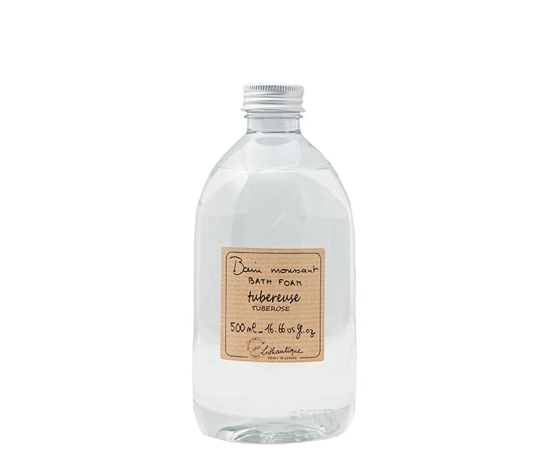 A clear plastic bottle containing a transparent, paraben-free liquid, labeled with a rustic, handwritten style sticker stating "Lothantique Tuberose Foam Bath," and specifying a content amount of 500ml.