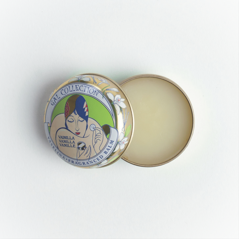 A small round tin of Perfumeria Gal Madrid vanilla fragrance moisturizing balm with the lid off. The lid features a colorful vintage design of a woman's face and floral motifs, labeled "Gail Collection Vanilla.