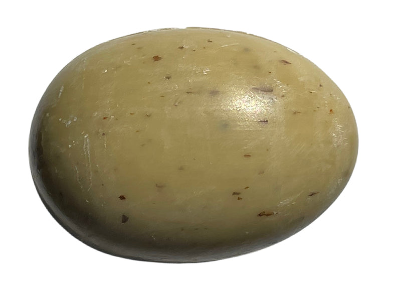 A close-up image of a single potato with a smooth, light-brown skin dotted with small dark specks, isolated on a white background, resembling a La Lavande Egg Soap - Verbena Leaf.