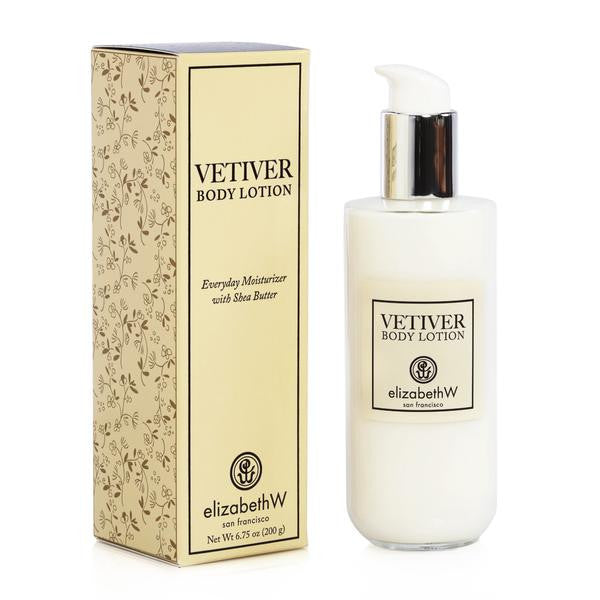 A bottle of elizabeth W Signature Vetiver Body Lotion with a pump dispenser next to its decorative box, which has a floral pattern. Both items feature prominent labeling.