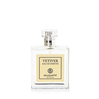 A clear glass perfume bottle labeled "elizabeth W Signature Vetiver Eau de Parfum" with a rectangular shape and a silver cap, against a white background.