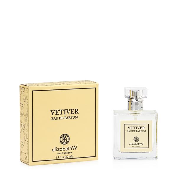 Image of a perfume bottle labeled "elizabeth W Signature Vetiver Eau de Parfum 1.7 fl oz" by Elizabeth W, next to its matching yellow box with decorative patterning. The bottle contains 1.7 oz