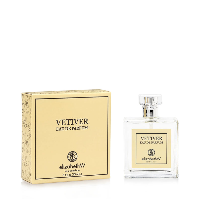 A bottle of elizabeth W Signature Vetiver Eau de Parfum 4oz next to its packaging box. The box and bottle labels feature elegant, simple typography on a cream background.
