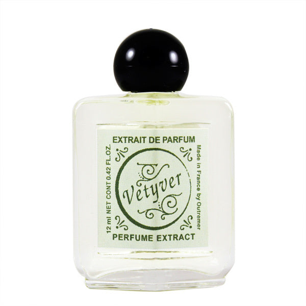 A clear square perfume bottle with a black spherical cap, labeled "Outremer - L'Aromarine Vetyver" in green, indicating it is a 2 fl. oz. unisex perfume extract. The bottle is centered on Outremer - L'Aromarine.