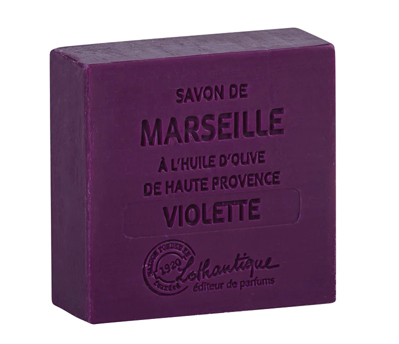 A purple soap bar labeled "Lothantique Les Savons de Marseille 100g Soap Violet" in embossed text, indicating French milled Marseille soap made with.