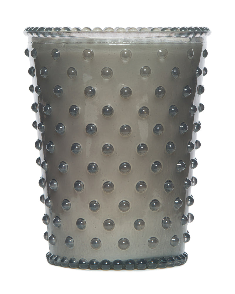 A silver, textured metal cup with embossed dots and a scalloped rim, isolated on a white background, reminiscent of the style used in Simpatico NO. 83 VIOLET Hobnail Glass Candles.