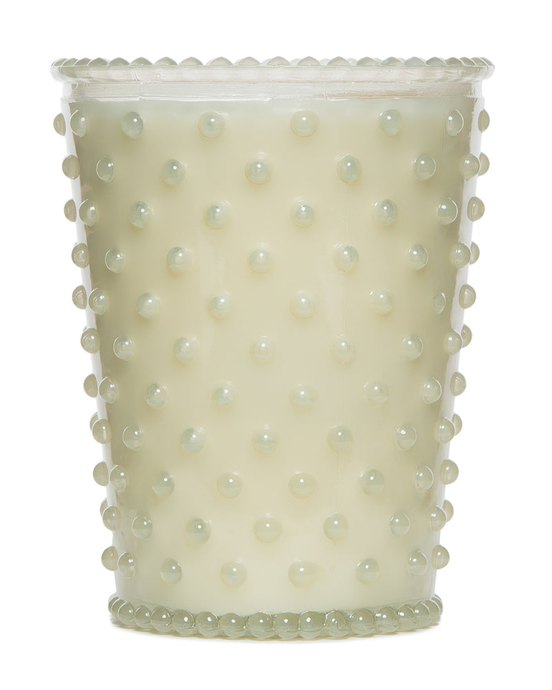 A Simpatico NO. 42 White Flower Hobnail Glass Candle with a milky white appearance and raised dot design, hand-poured, isolated on a white background.