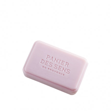 A pink bar of Panier des Sens Extra-Soft Vegetable Soap - Wild Fig with the embossed text "panier des sens en Provence" on a plain white background, infused with shea butter.