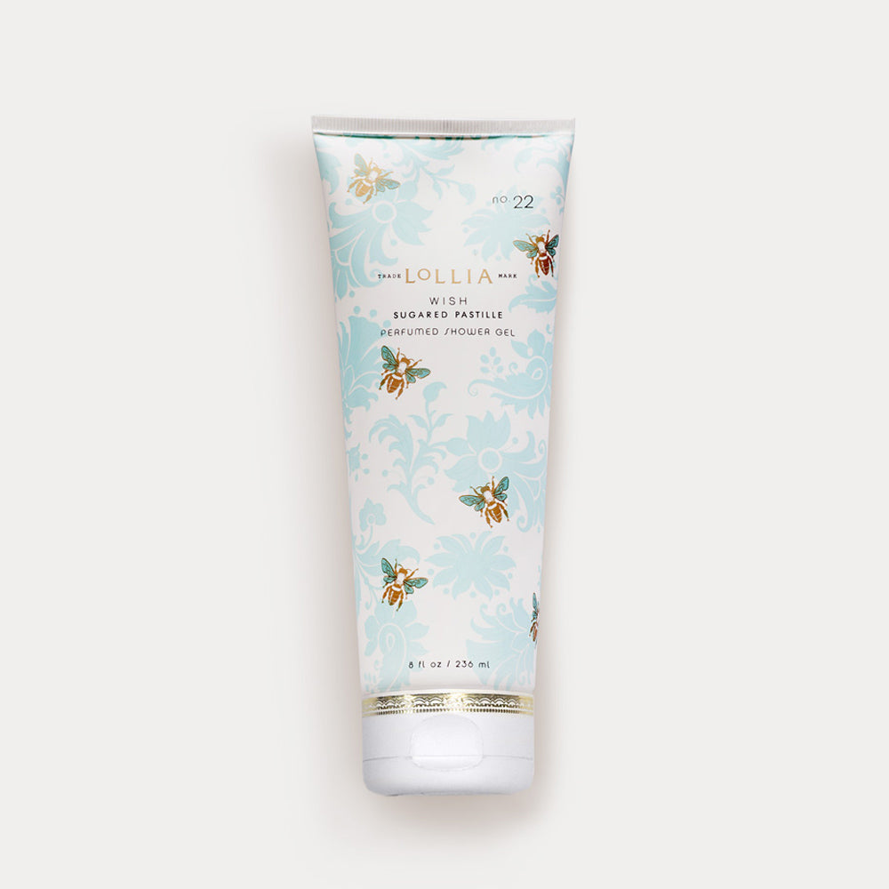 A tube of Margot Elena brand Lollia Wish perfumed shower gel on a white background, featuring an elegant blue and gold floral design with hints of Jasmine Leaves.